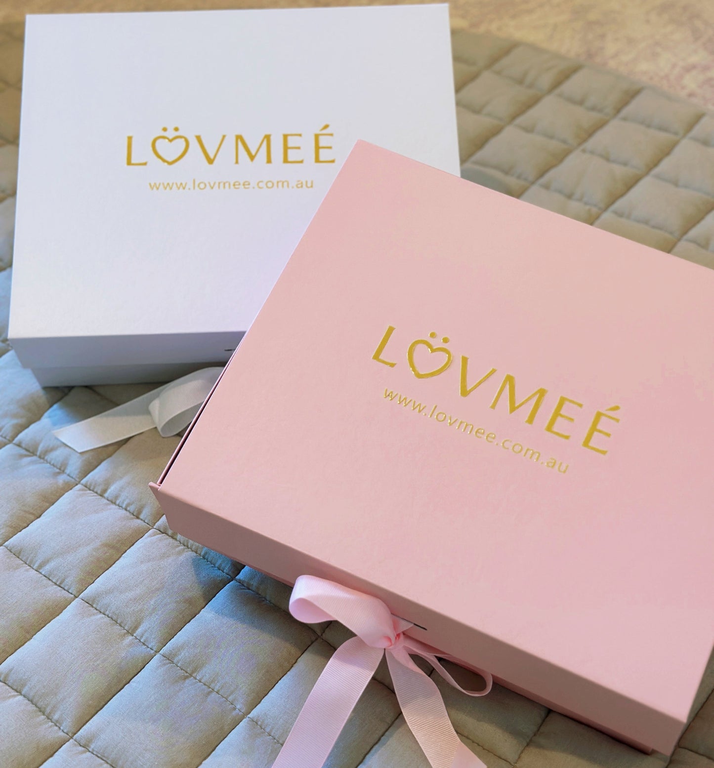 Two boxes with 'LOVMEE' branding on a textured surface