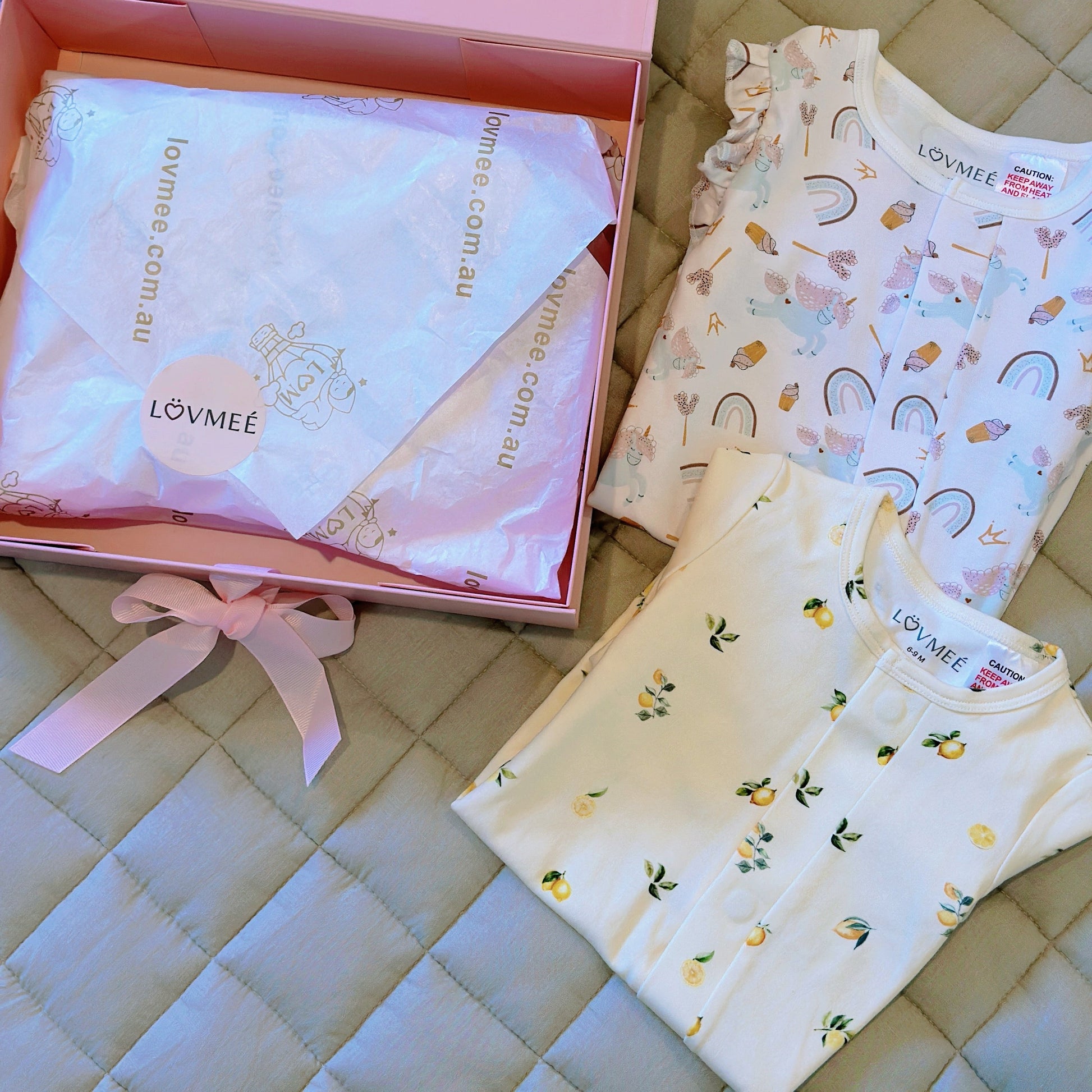 Baby clothing and accessories from LOVMEE on a quilted surface