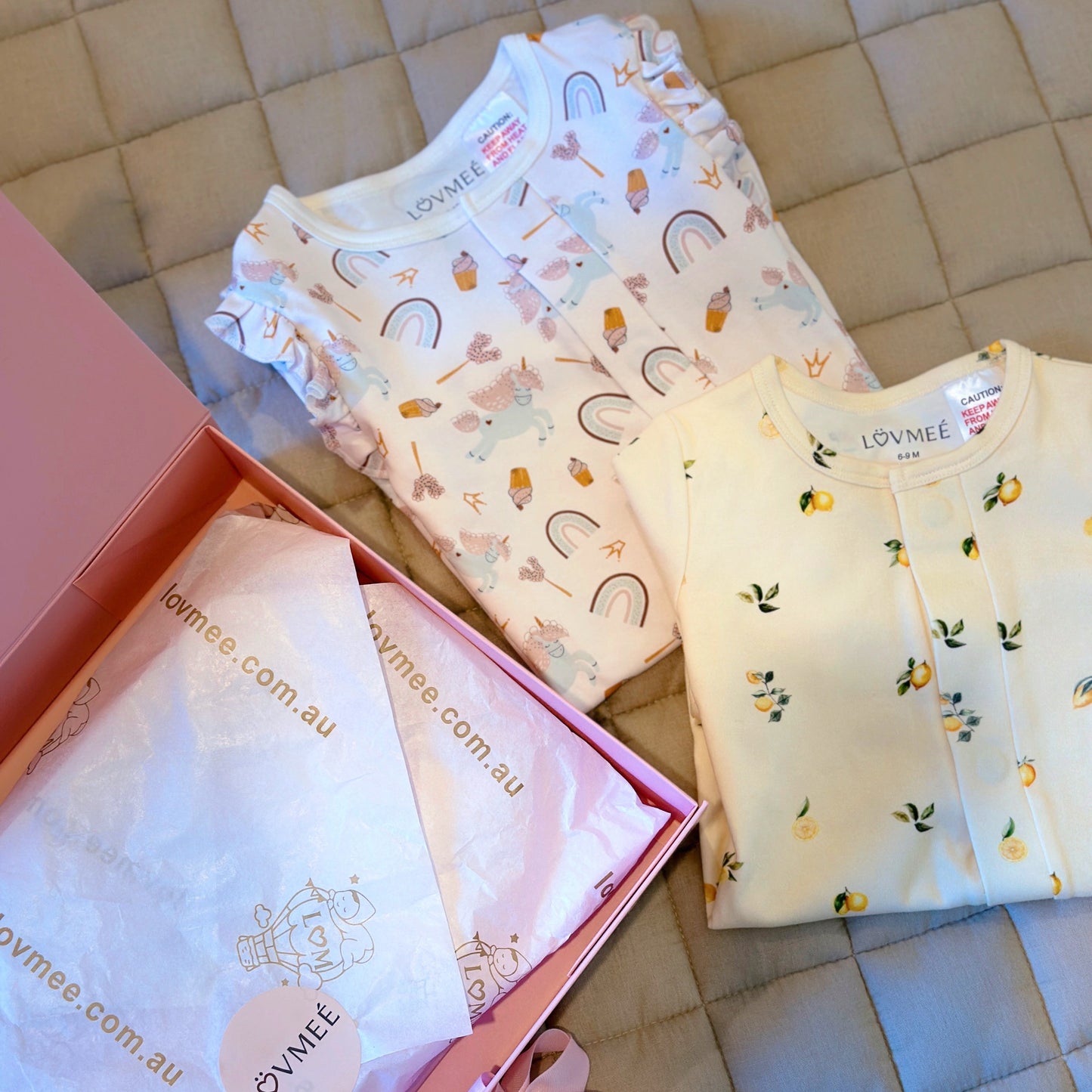 Baby clothing set with 'LOVME' branding on a tiled floor.
